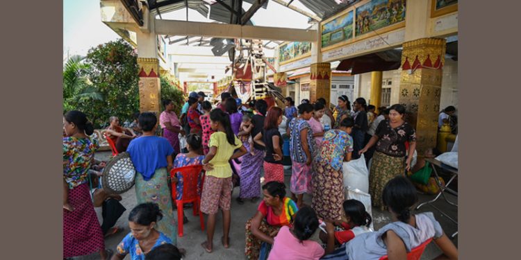 ၂၀၂၃ ခုနှစ်၊ မေလ ၁၇ ရက်နေ့က စစ်တွေမြို့ရှိ ဘုန်းကြီးကျောင်းတွင် ကမ္ဘာ့စားနပ်ရိက္ခာအစီအစဉ် (WFP) က ပေးသည့်ဆန်ကို တန်းစီစောင့်ဆိုင်းနေကြသူများ / AFP